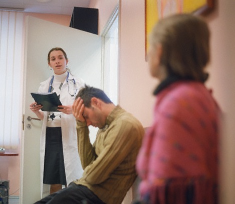 Doctor calling patient from waiting room --- Image by © Mika/Corbis